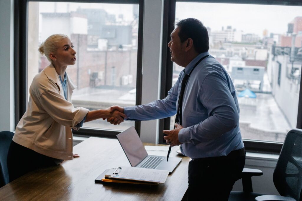 Candidate shaking hands with an employer before a job interview